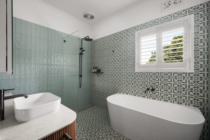 Modern bathroom design featuring a freestanding bathtub, patterned wall tiles, and a glass shower enclosure, illustrating home renovation aesthetics and style.