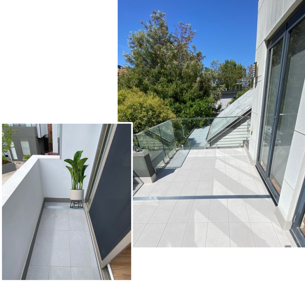 Modern balcony with gray tiles, glass railing, and potted plant, showcasing a clean and renovated outdoor space suitable for balcony renewal services in Melbourne.